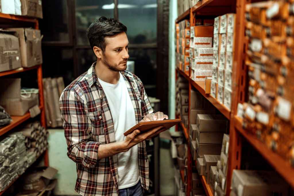 Man checking warehouse inventory on tablet
